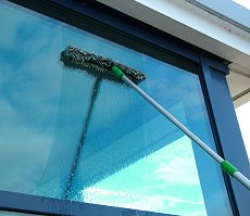 window cleaning with a scrubber and squeegee