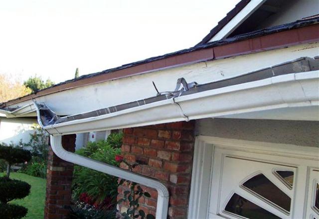 Damaged rain gutters on home in Yucaipa, California 