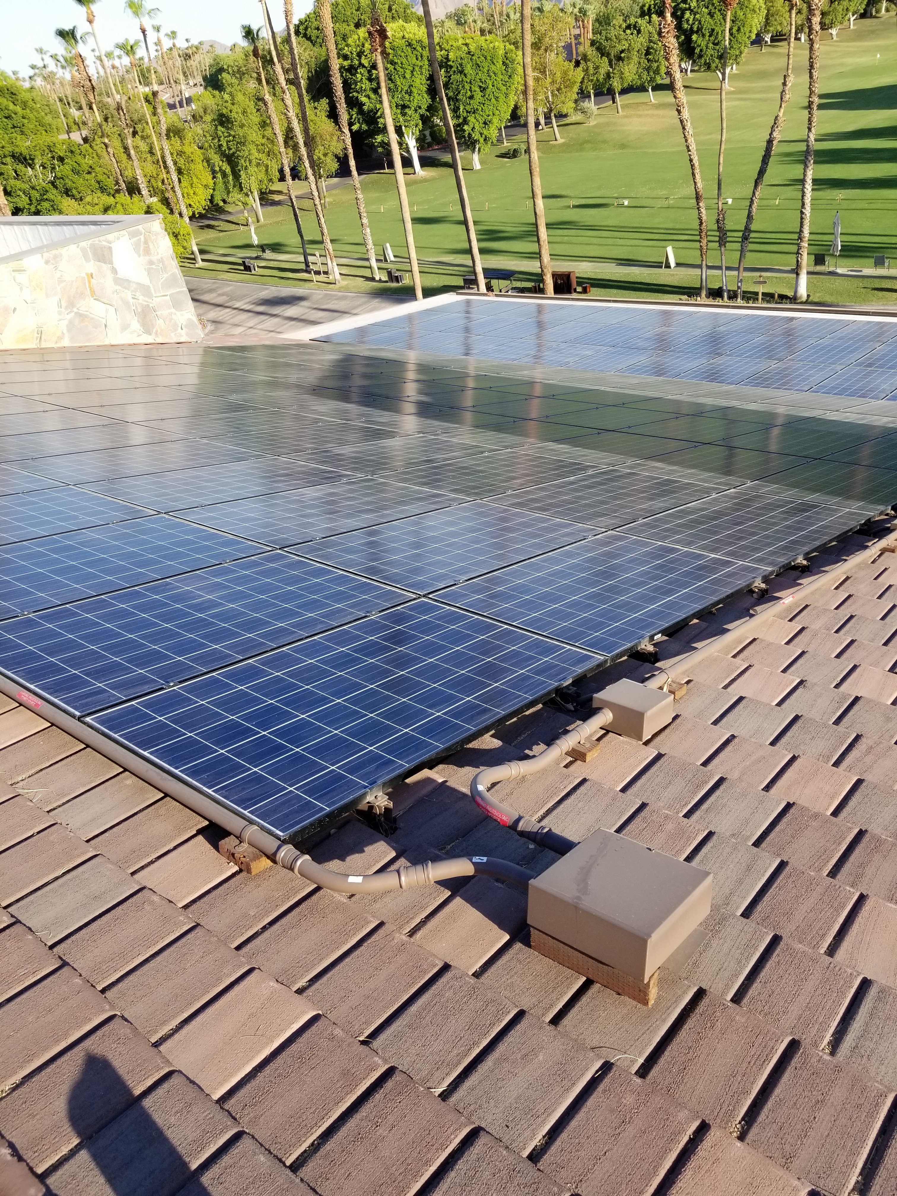 Roof mounted solar panels Roof mounted solar panels on top of the Clubhouse at the Lakes Country Club in Palm Desert, California