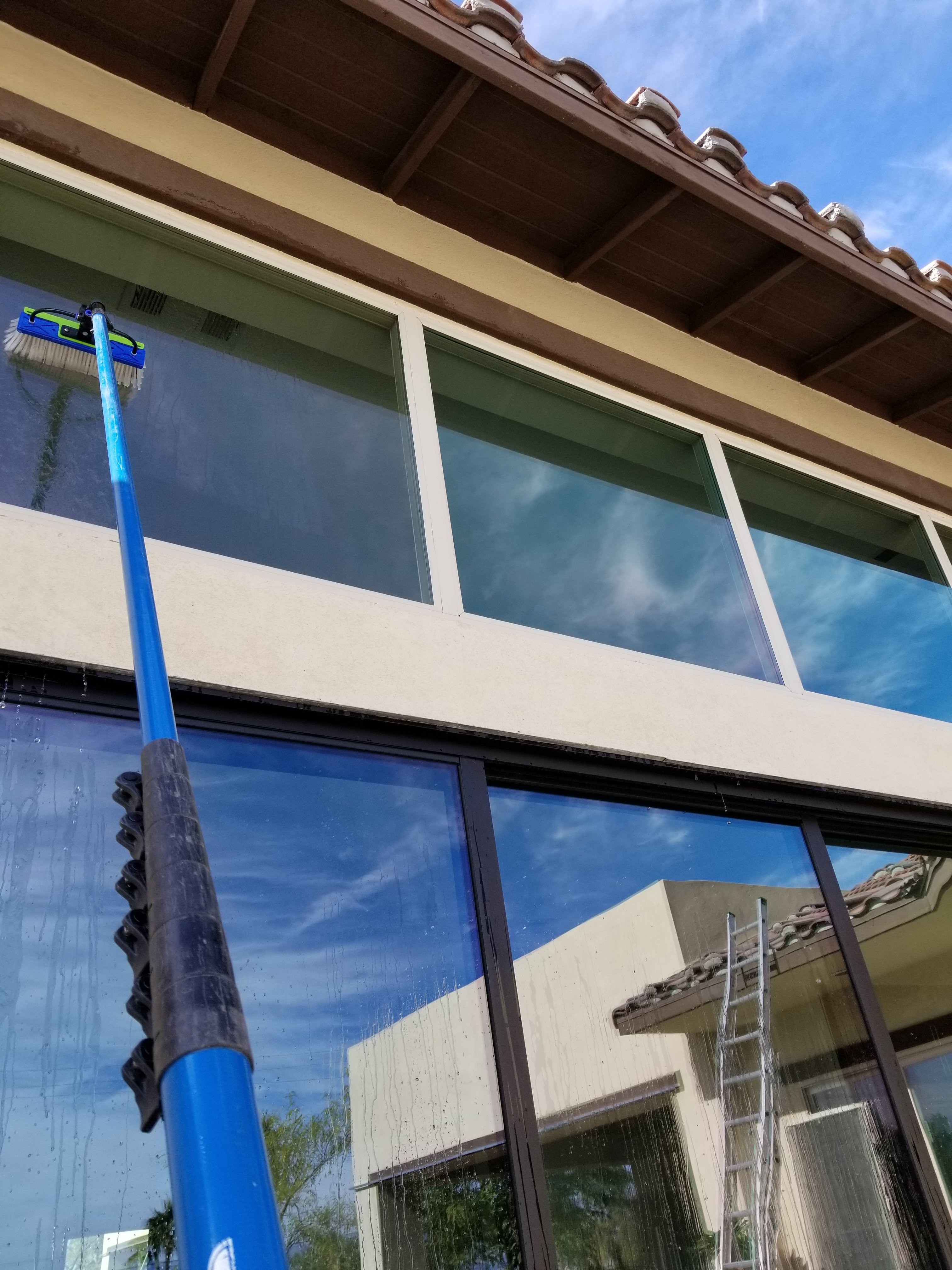 Window cleaning with a water fed pole on home in Tuscany Heights, Palm Springs, California 