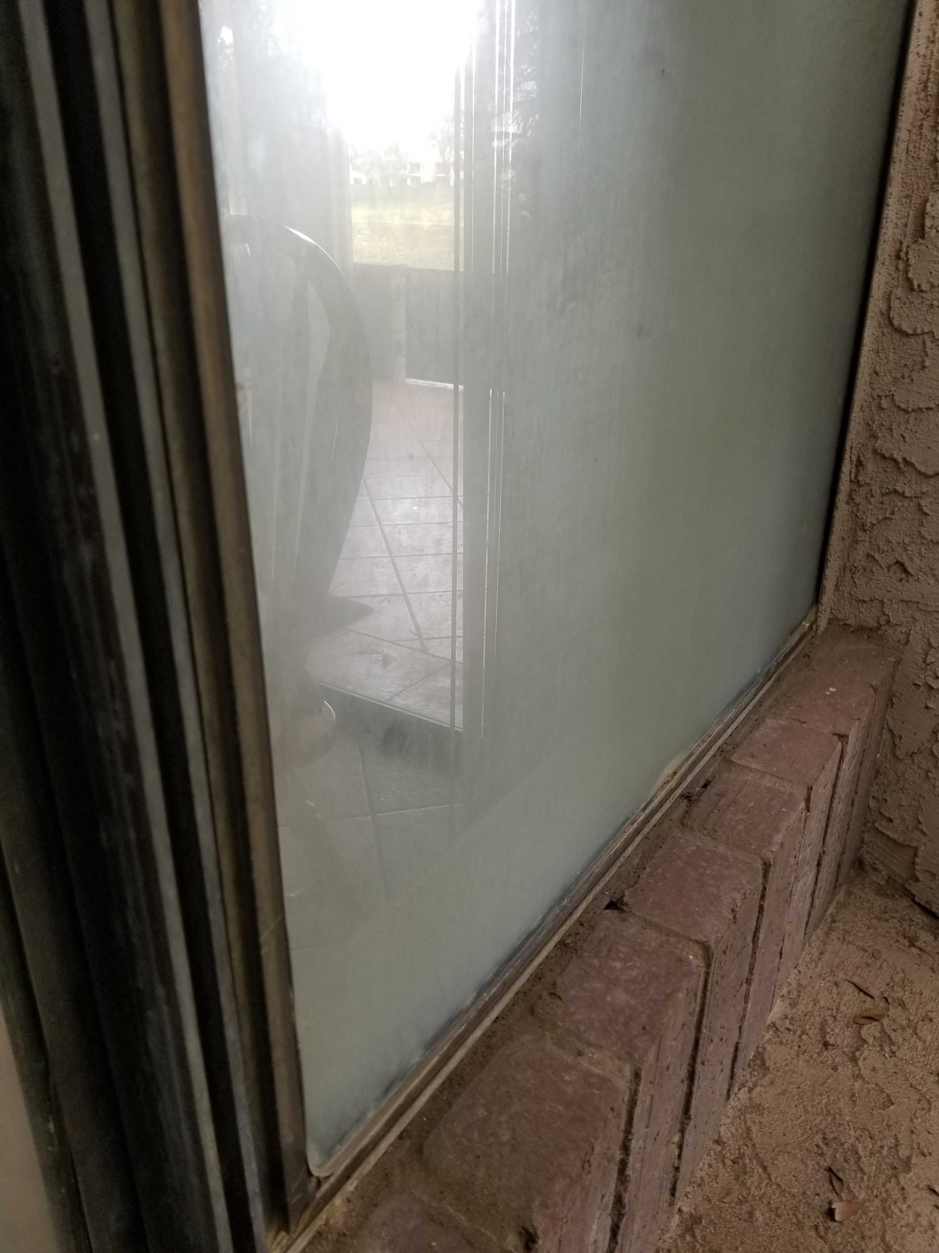 Hard water stains on window in Cathedral Canyon Country Club in Palm Springs, California 