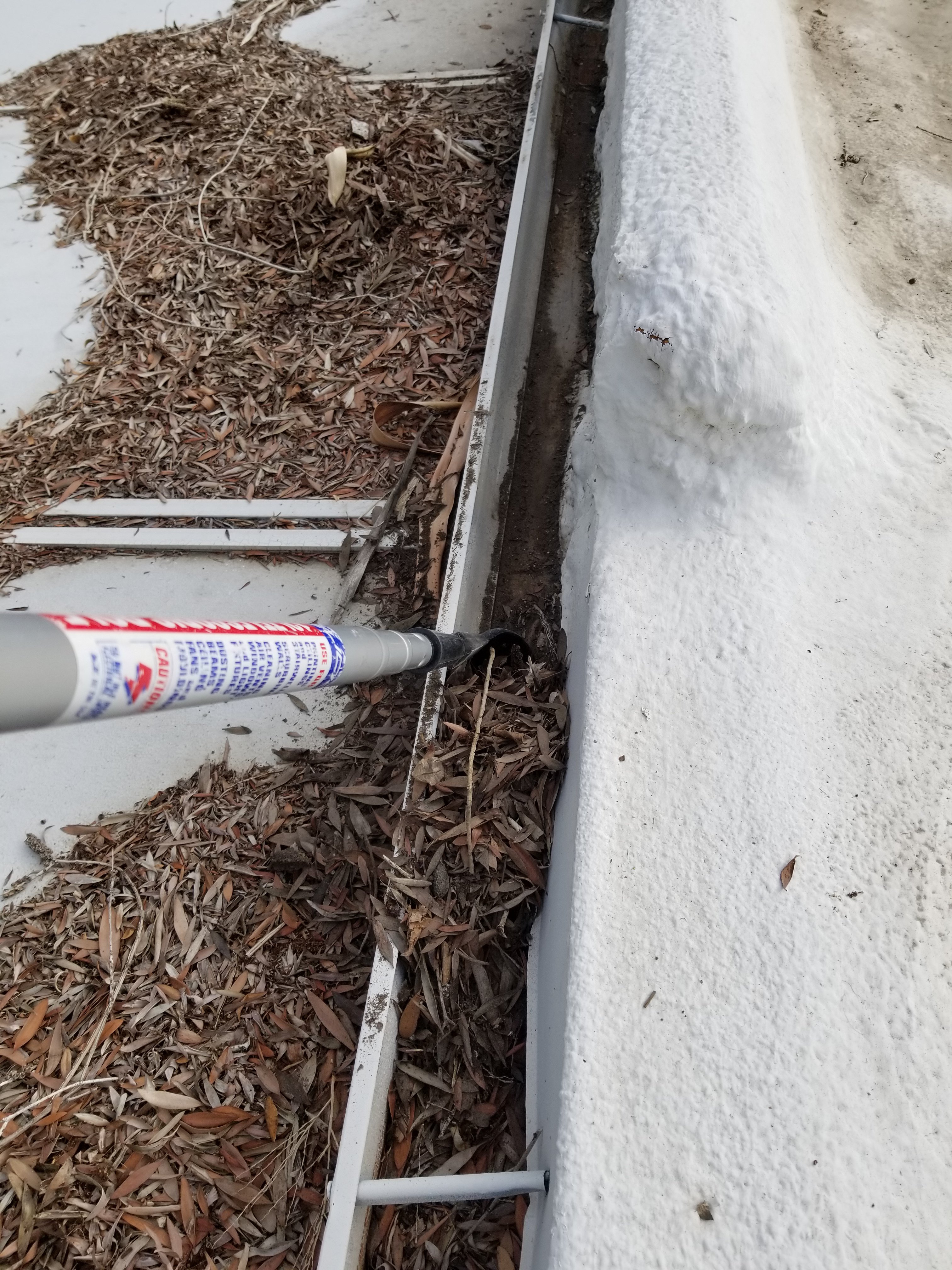 Gutter cleaning with gutter scoop on home in Palm Springs, California 